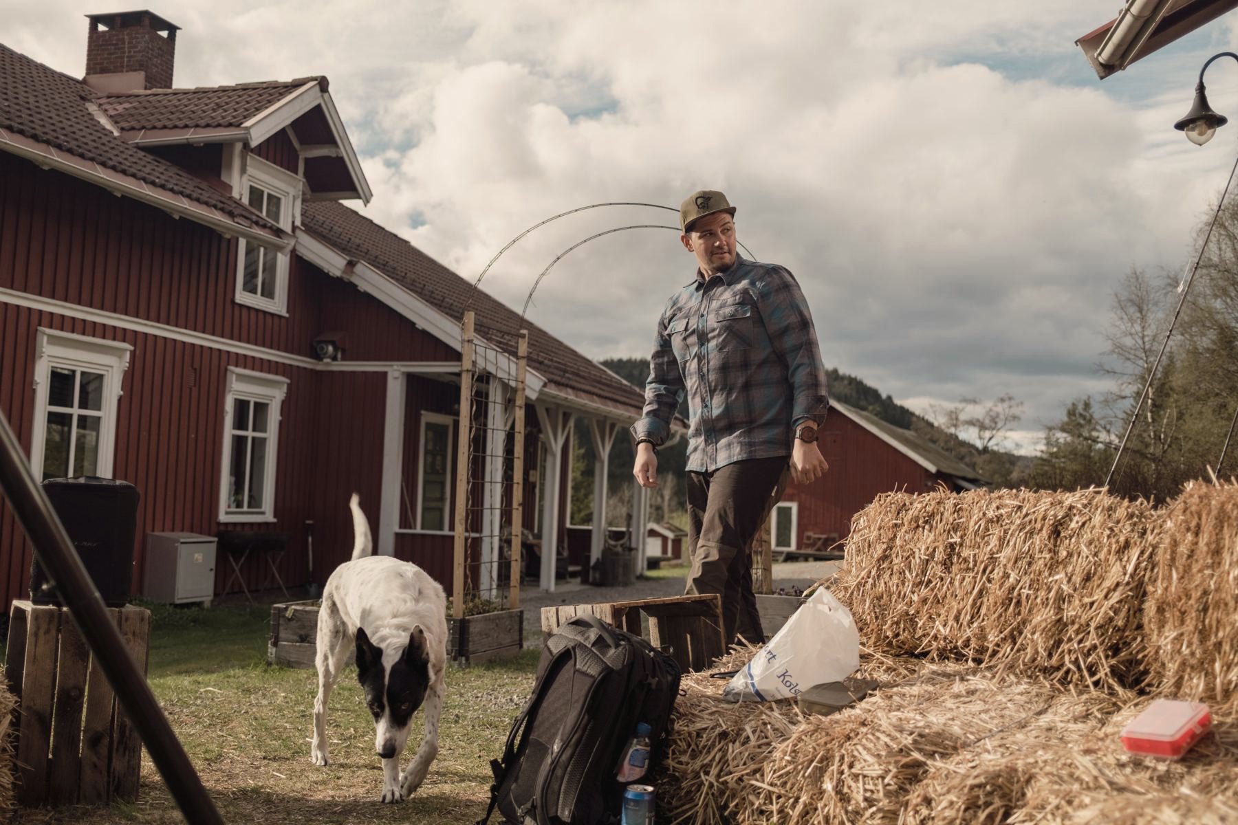 Hund og gjest foran hovedhuset.